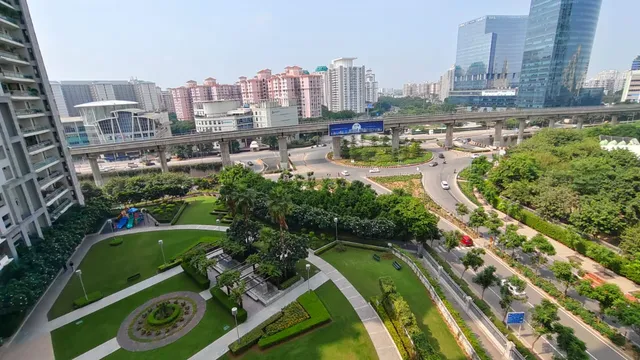 Panoramic view of DLF Golf Course and greenery from a high-floor balcony at DLF The Belaire.-The Soni Landbase