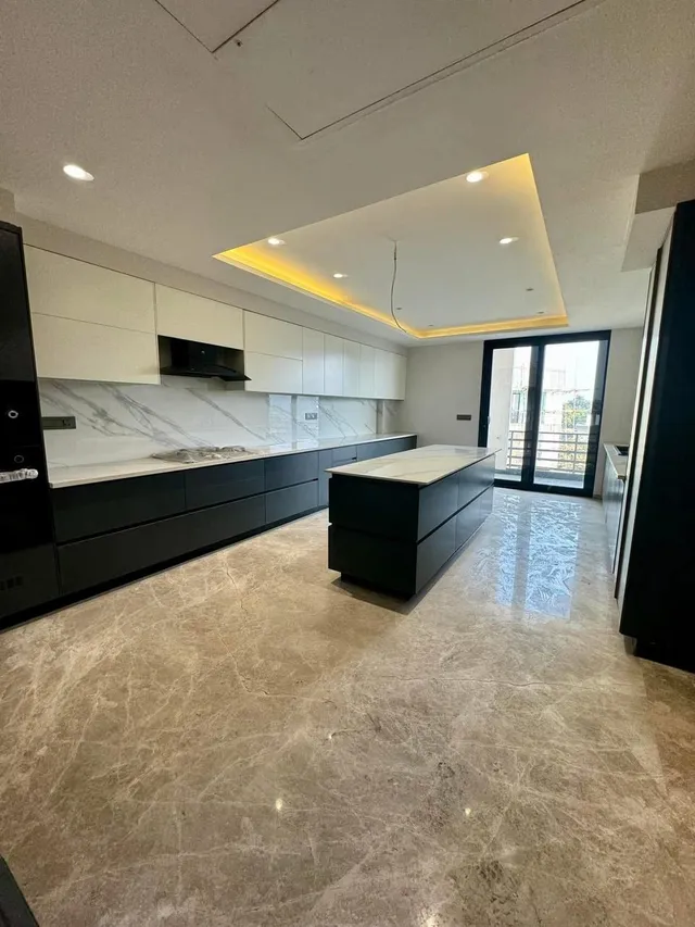 Modular designer kitchen with high-end appliances at DLF The Magnolias luxury residence.- TSL