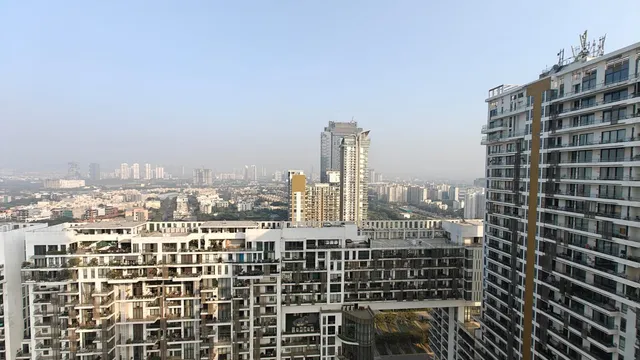 Panoramic high-floor view of M3M Golfestate towers and landscaped 9-hole executive golf course- The Soni Landbase