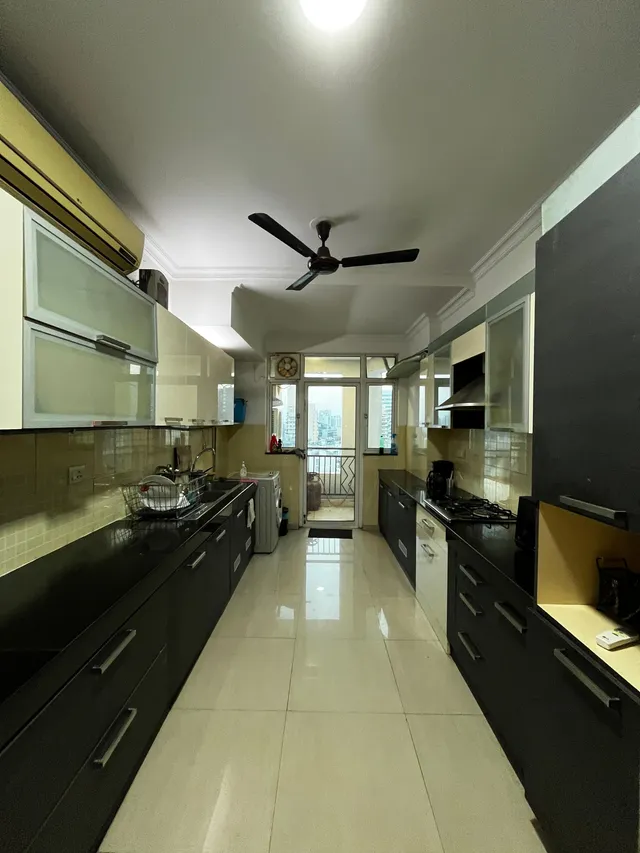 Fully equipped modular kitchen with high-end appliances at DLF The Pinnacle DLF Phase 5.- The Soni Landbase